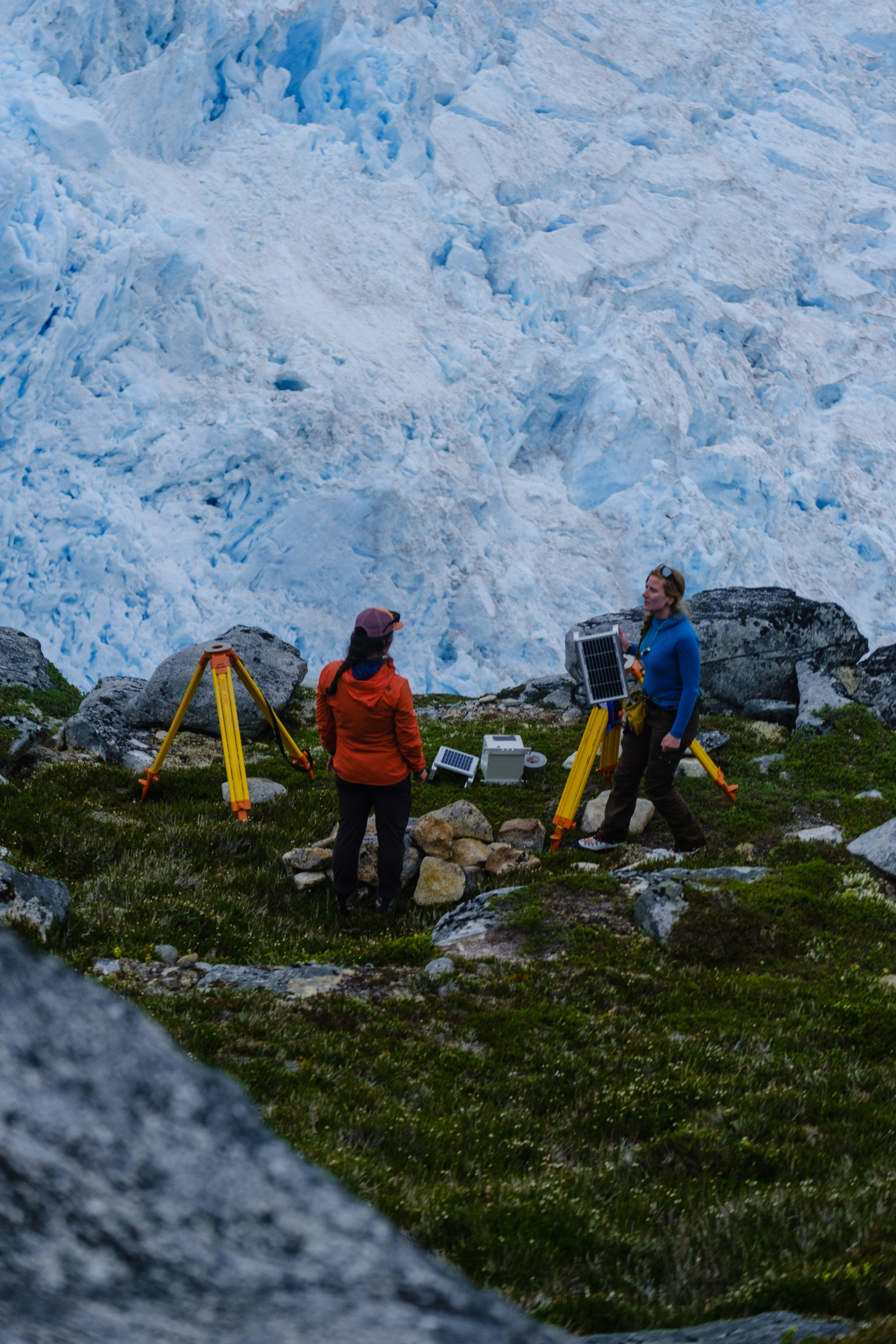 Two staff members in front of the icefield, setting up time-lapse cameras.