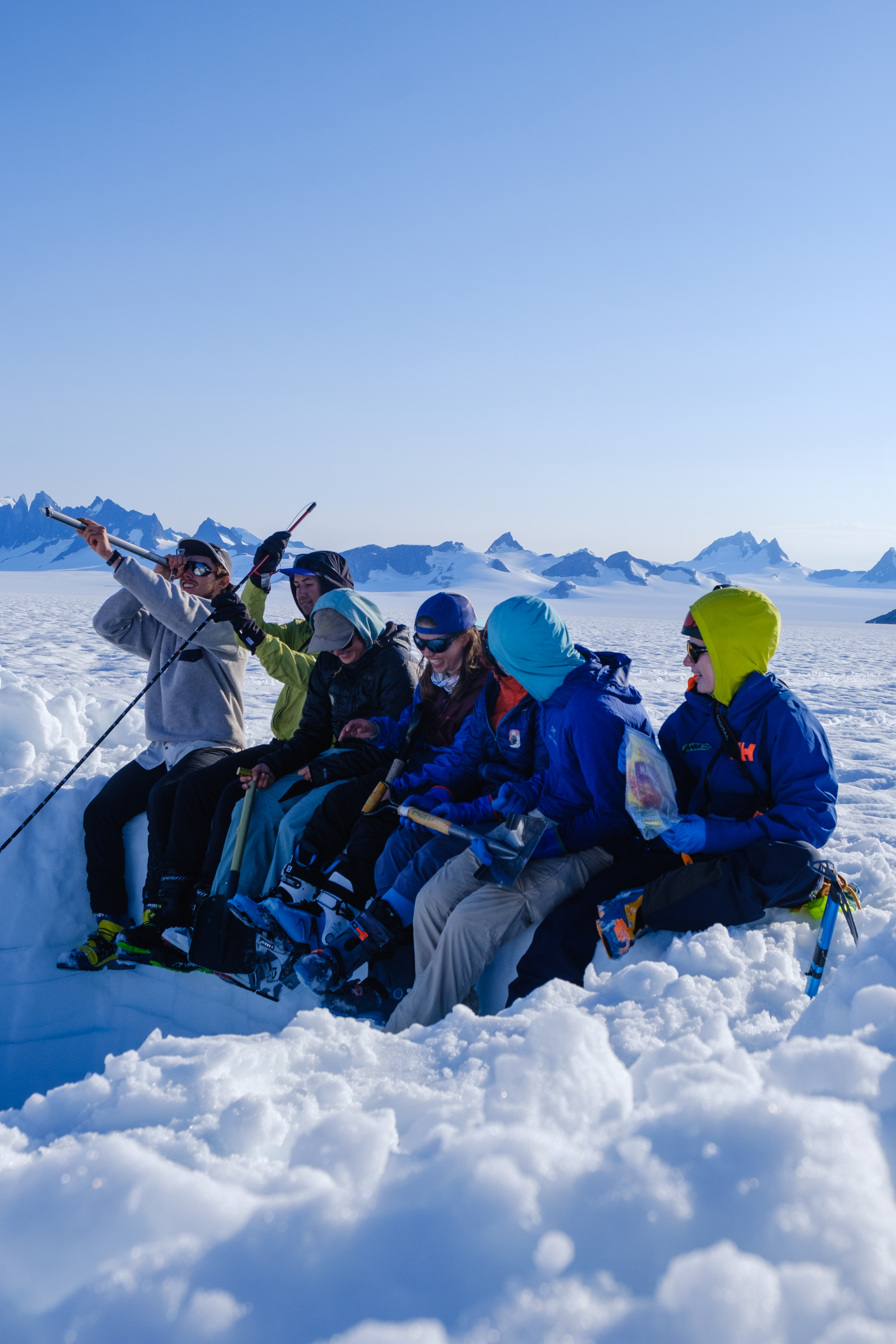 Some of my icefield friends, sitting happy in a snow pit they dug for science. They are goofing around in the sun, you can feel the warm atmosphere, and that this isn't their first snow pit.